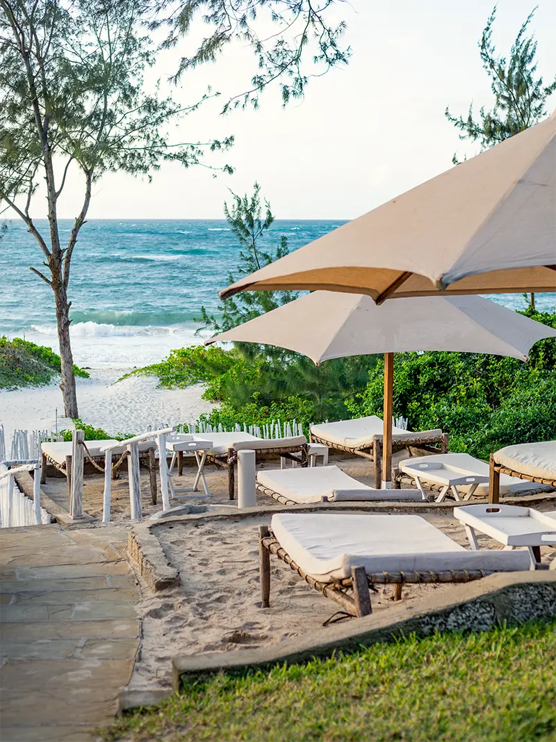 Beachfront loungers and umbrellas overlooking the white sands of Garoda Beach in Watamu
