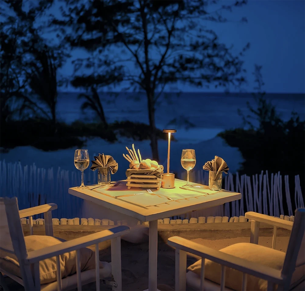Romantic beachfront dinner setting overlooking the ocean at Kobe Suite Resort