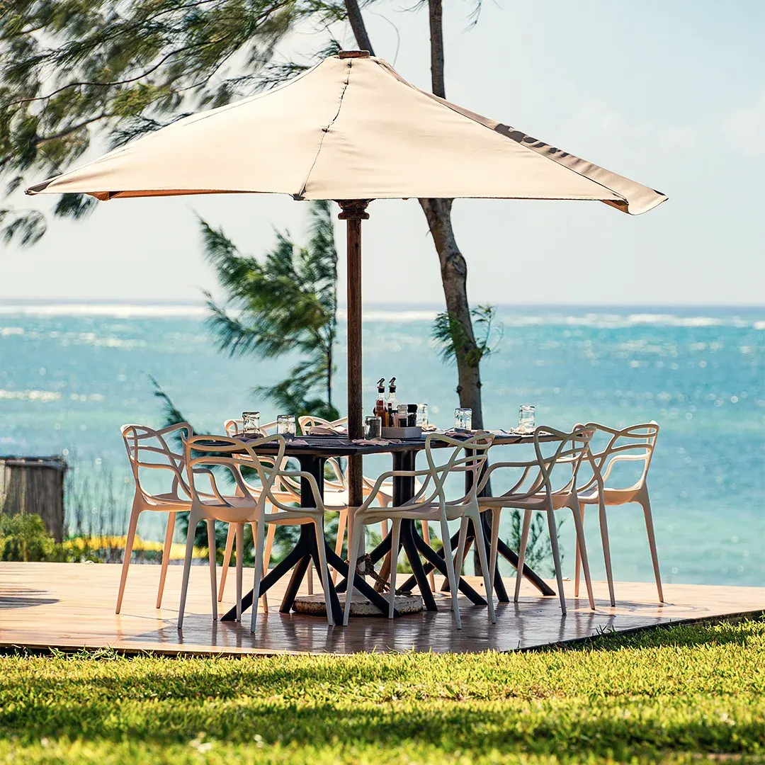 Outdoor dining terrace with ocean views at Kobe Suite Resort