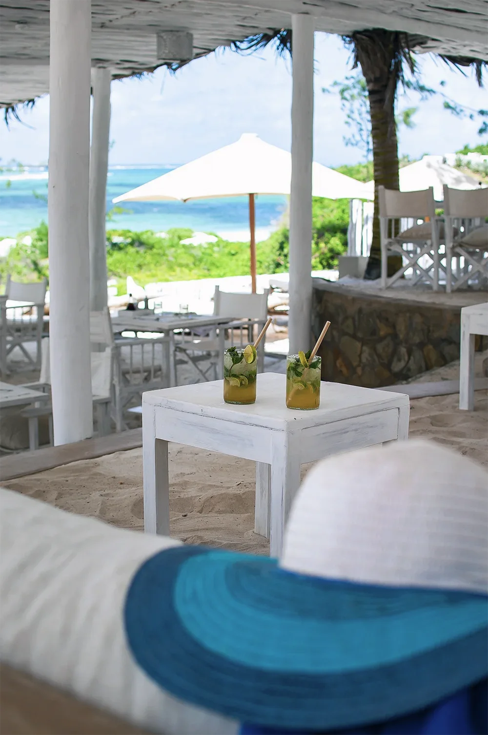 Two cocktails served in a beachfront dining area overlooking the Indian Ocean