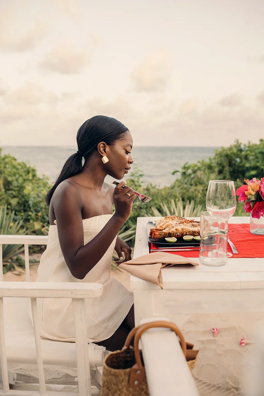 Woman enjoying a romantic dinner overlooking the Indian Ocean at Kobe View Point