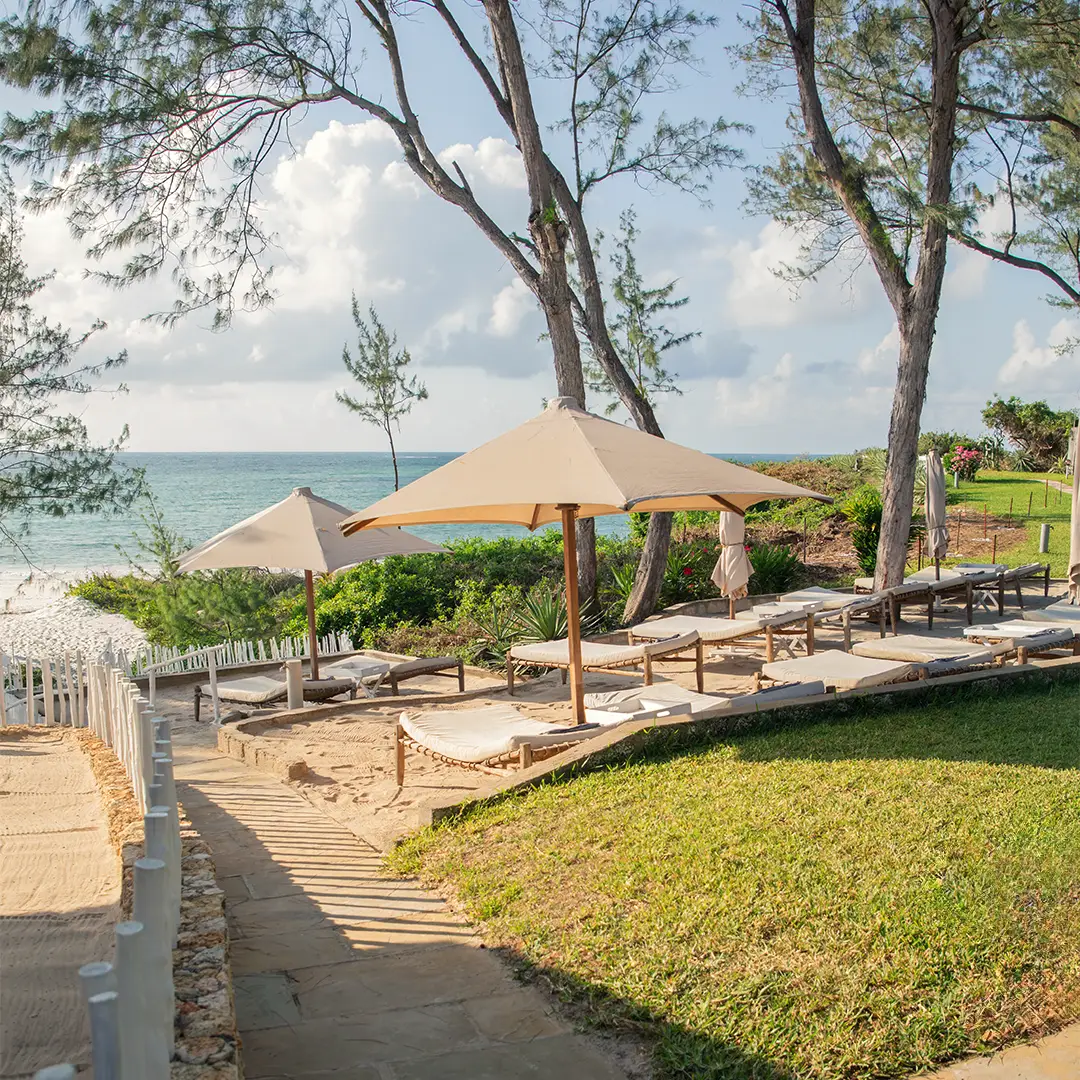 Private beach area with sun loungers overlooking the Indian Ocean at Kobe Suite Resort