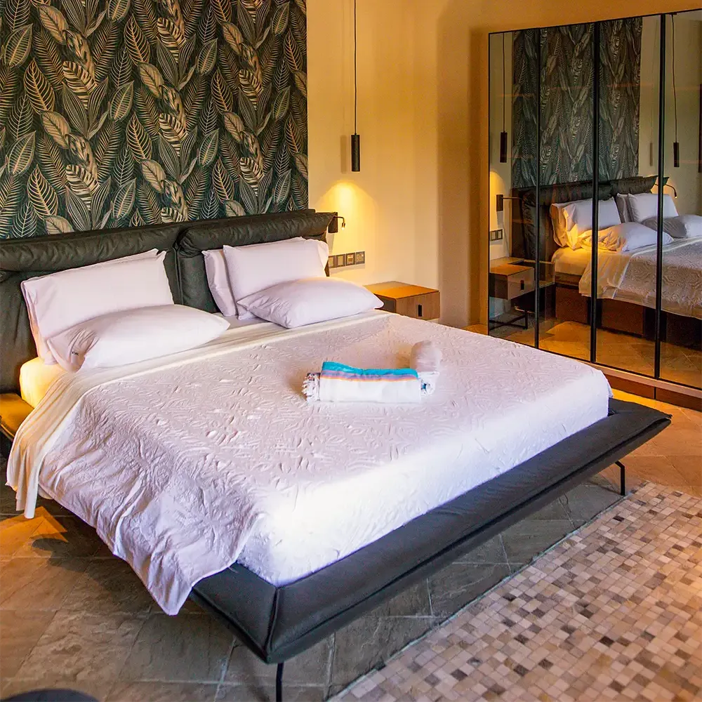 Romantic Ocean View Suite bedroom with king-size bed and tropical-inspired decor