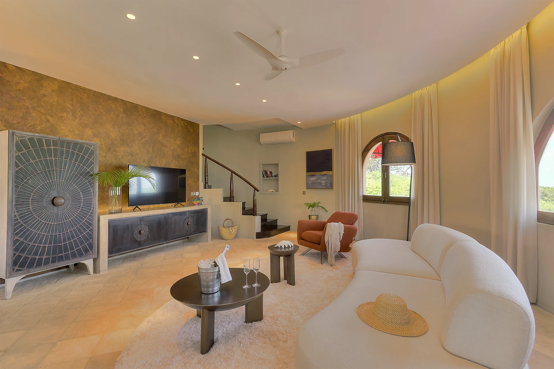 Spacious living room with seating area and TV in the Presidential Ocean View Suite