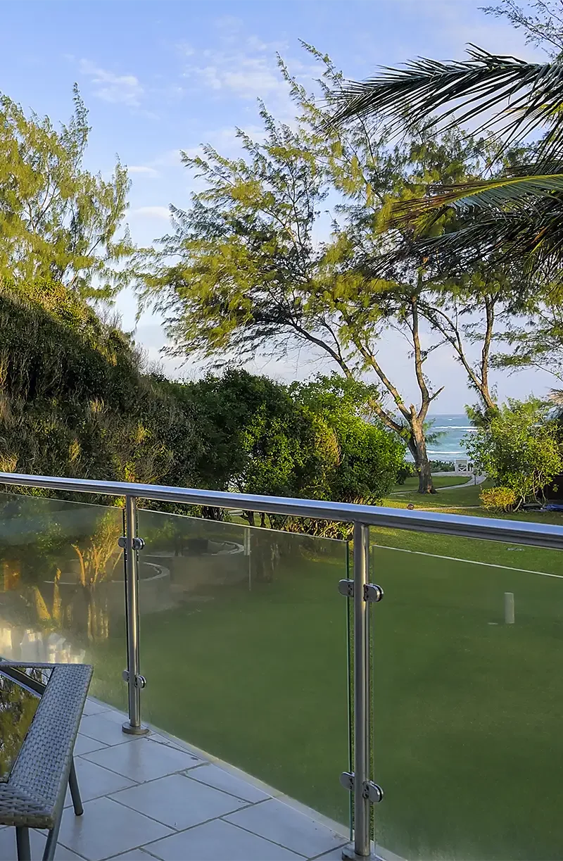 Deluxe Ocean View Suite terrace overlooking the tropical gardens and Indian Ocean