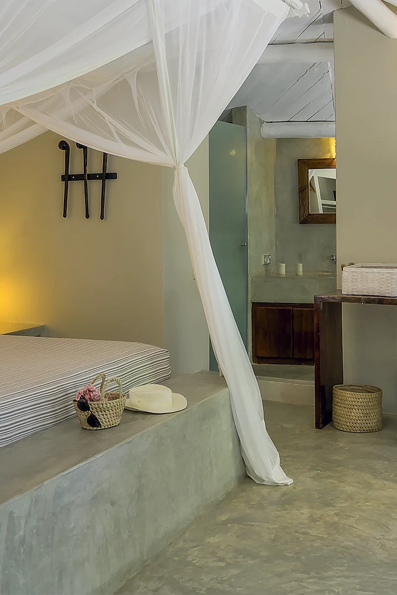 Deluxe Ocean View Suite bedroom with dressing area and en suite bathroom