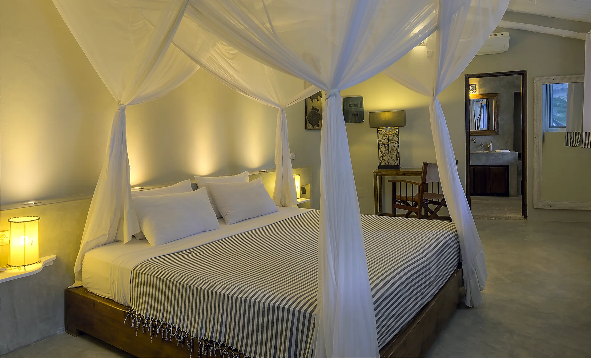 Deluxe Ocean View Suite bedroom with king-size bed and mosquito net