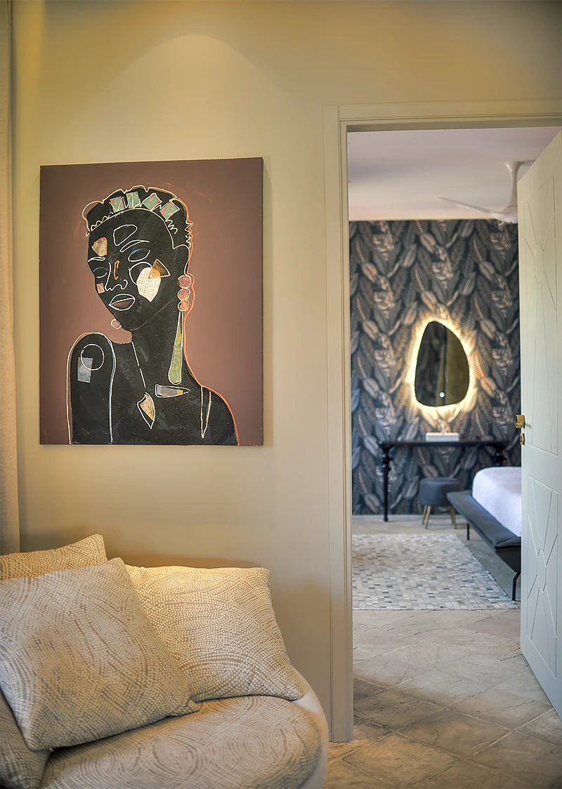 Presidential Ocean View Suite sitting area with African-inspired artwork and bedroom beyond
