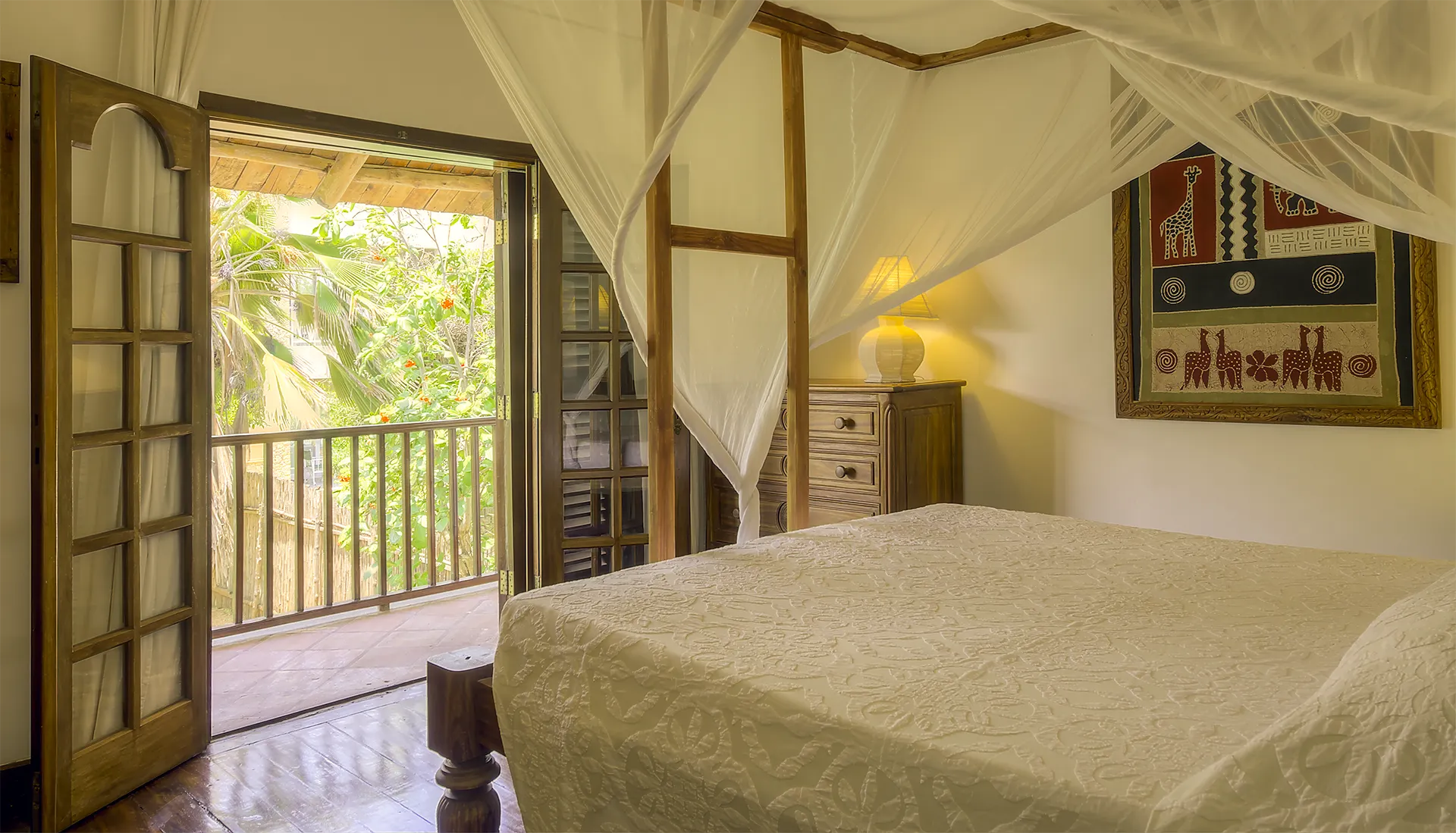 Private Villa bedroom with four-poster king-size bed overlooking the tropical garden