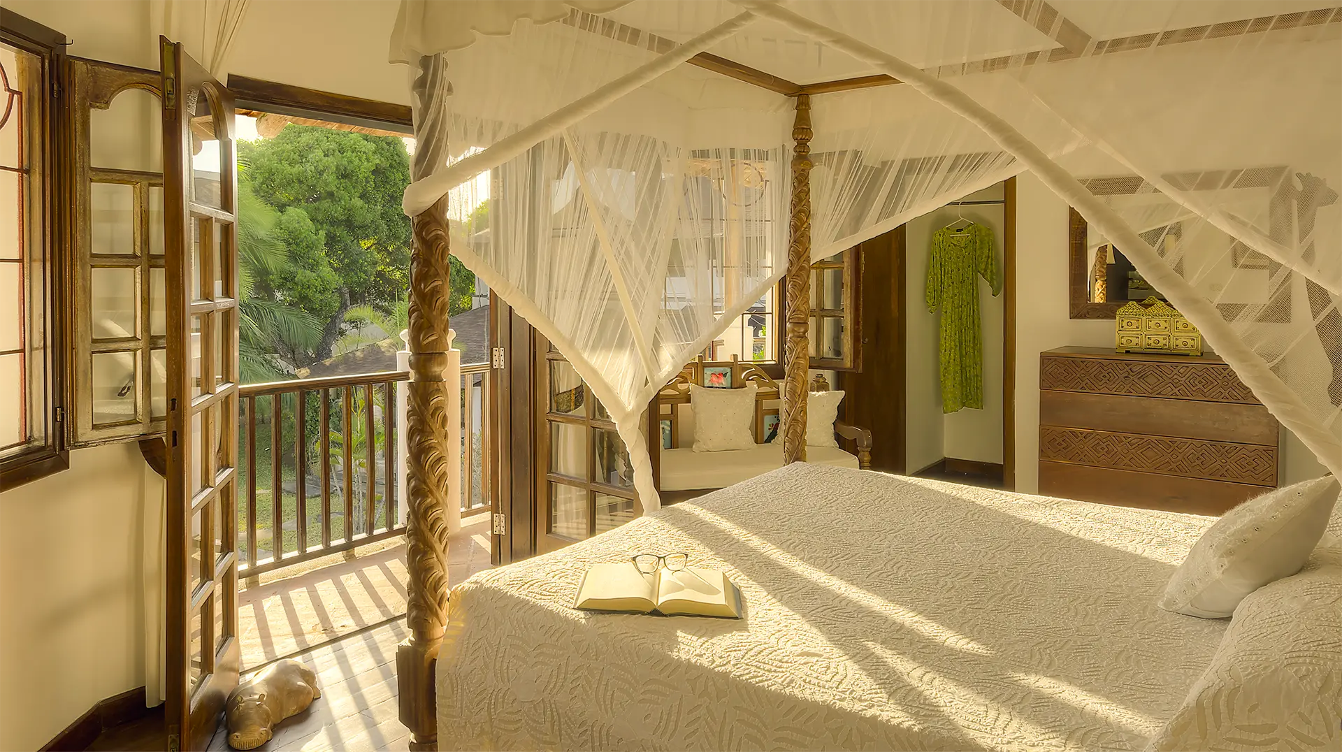 Private Villa bedroom with four-poster king-size bed overlooking the tropical garden