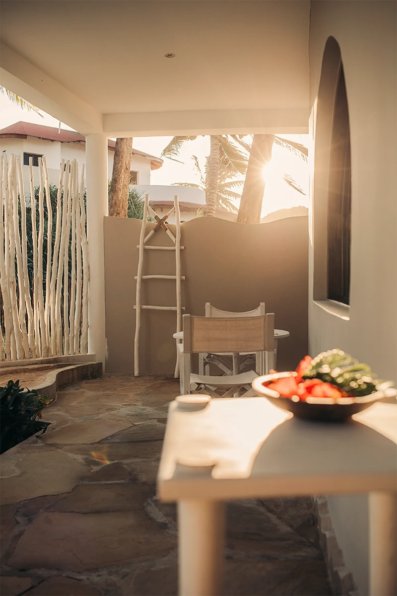 Private veranda with outdoor seating overlooking the tropical garden at the Premium Garden View Suite