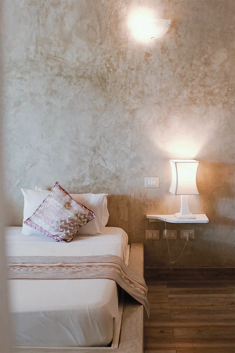 King-size bed and bedside table in the Deluxe Garden View Suite