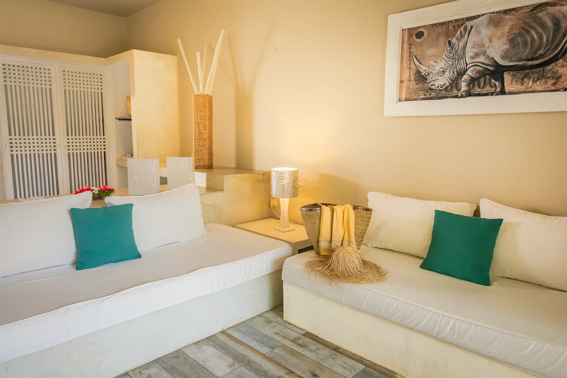 Deluxe Garden View Suite living area with sofa and tropical garden views