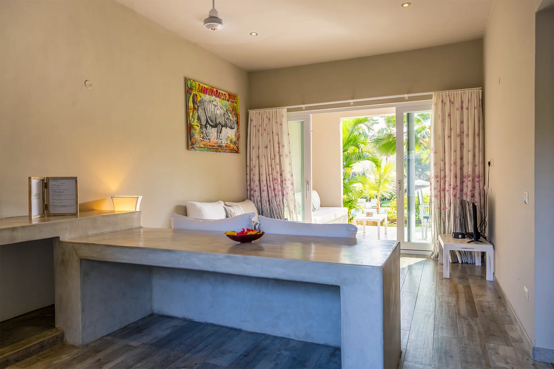 Deluxe Garden View Suite living area with sofa and tropical garden views