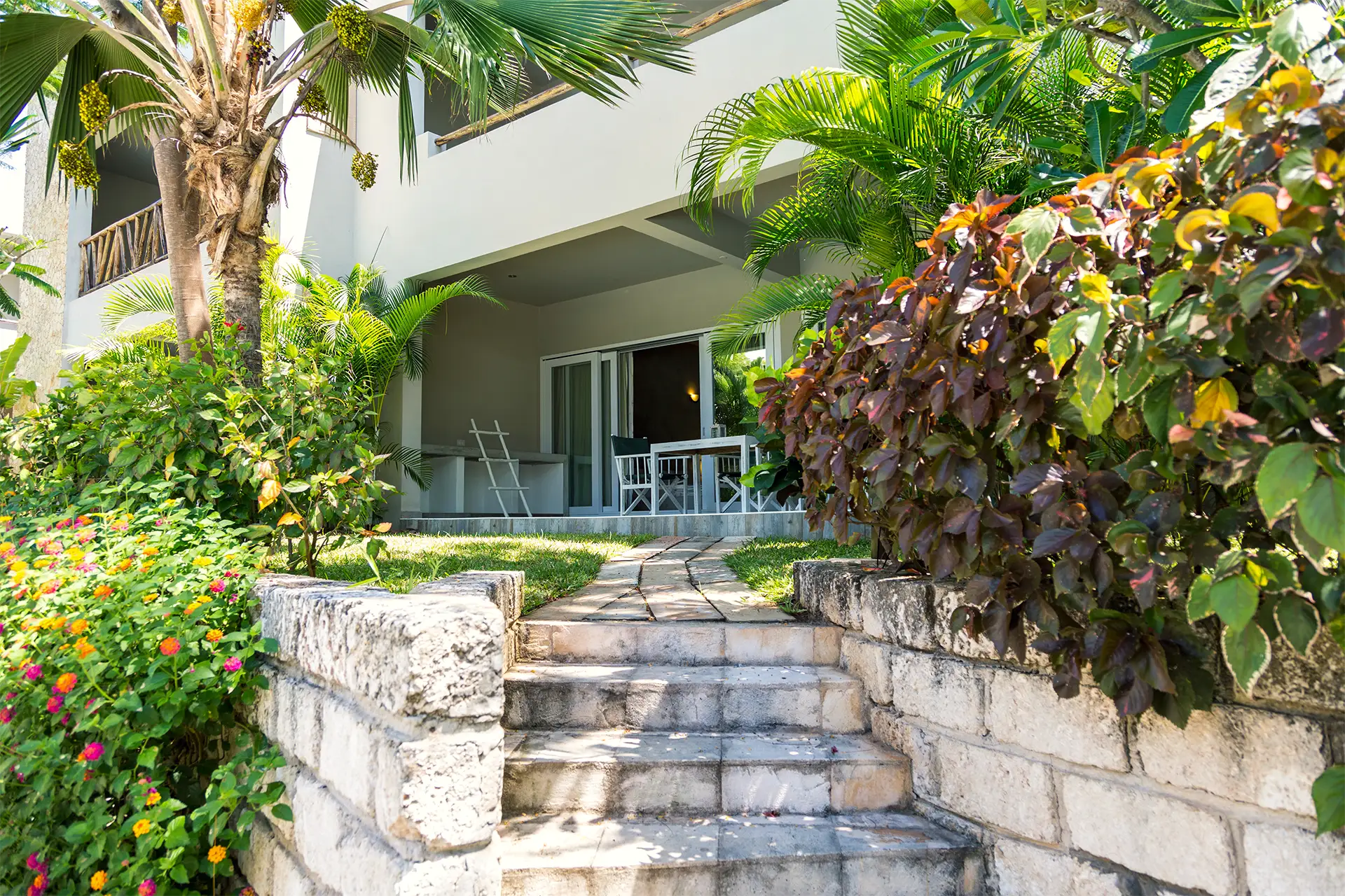 Deluxe Garden View Suite entrance surrounded by lush tropical gardens