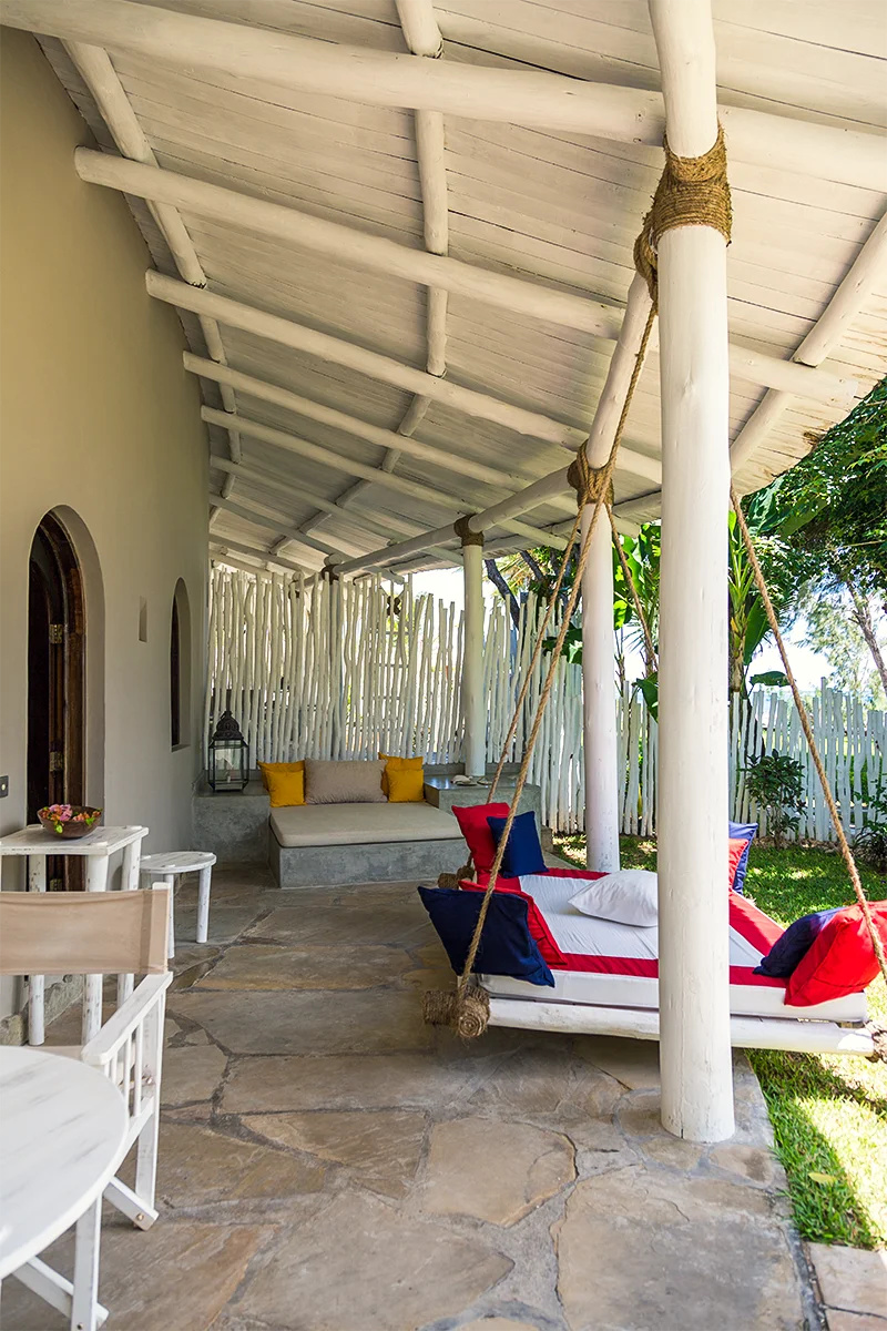 Private veranda with outdoor seating and hanging daybed at the Ocean View Suite