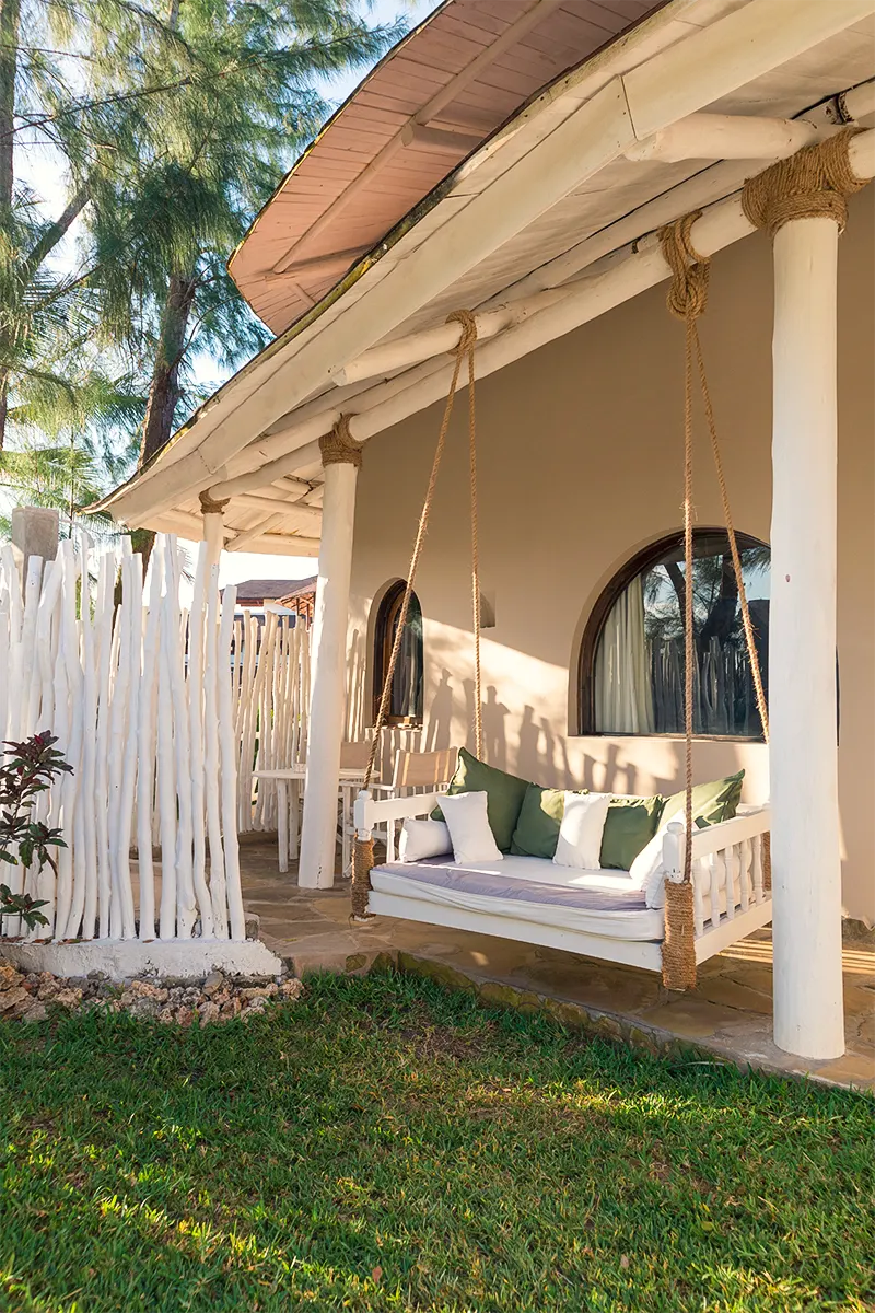 Covered veranda with a hanging daybed at the Ocean View Suite