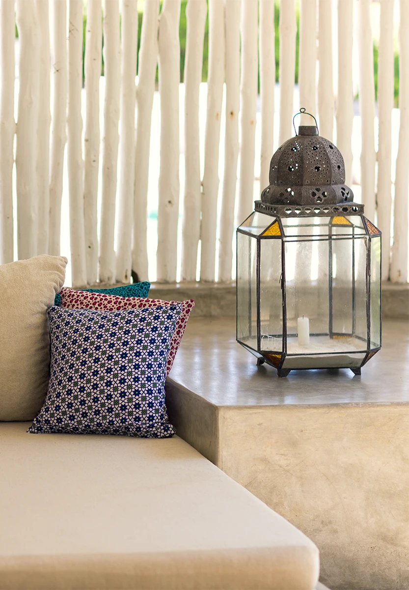 Cushioned seating and decorative lantern inside the Ocean View Suite