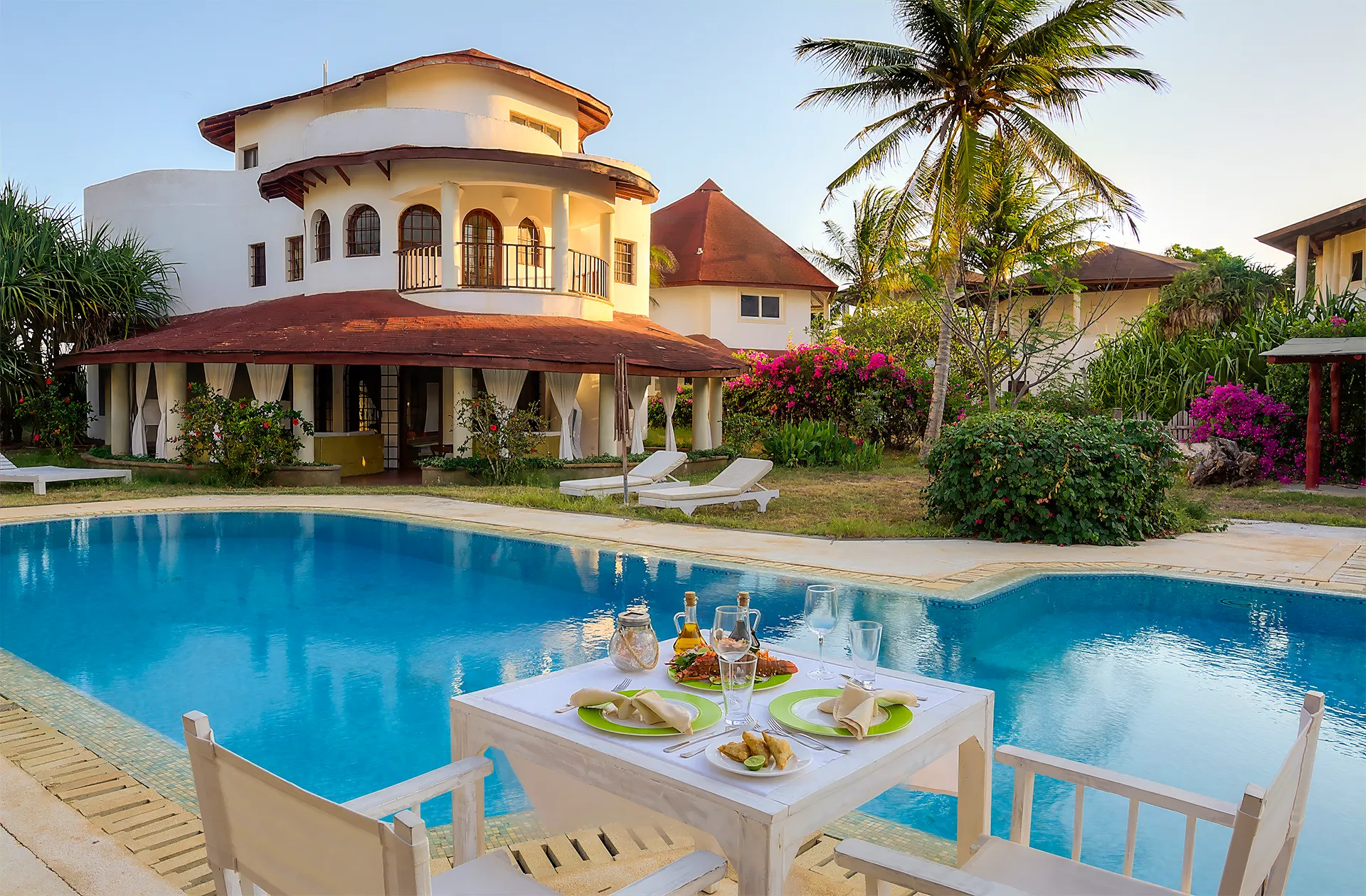 Private villa with swimming pool, tropical gardens and outdoor dining area