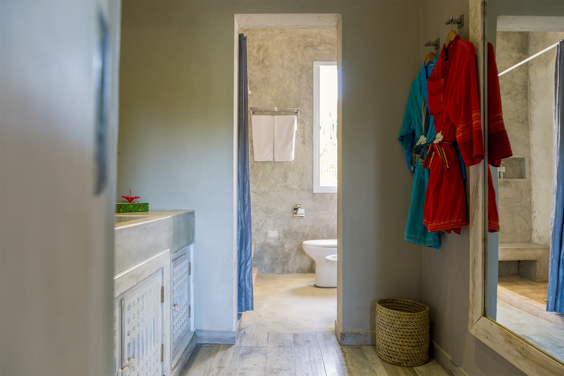 Bathroom and dressing area with colorful robes in the Standard Garden View Suite