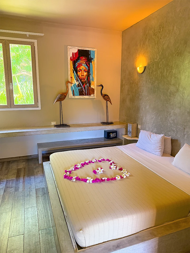 Standard Garden View Suite bedroom with king-size bed and African-inspired decor