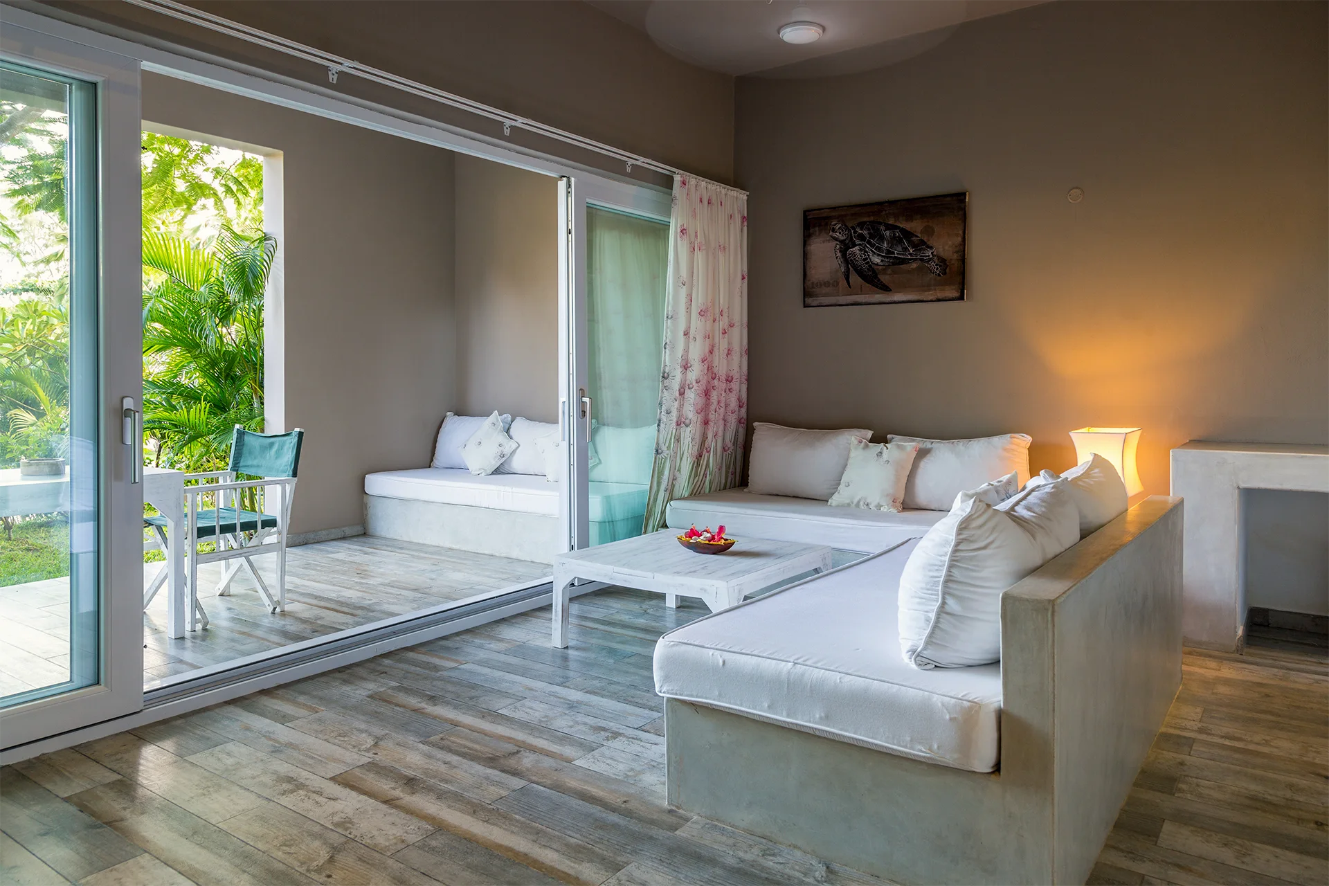 Standard Garden View Suite living area with indoor seating and tropical garden views