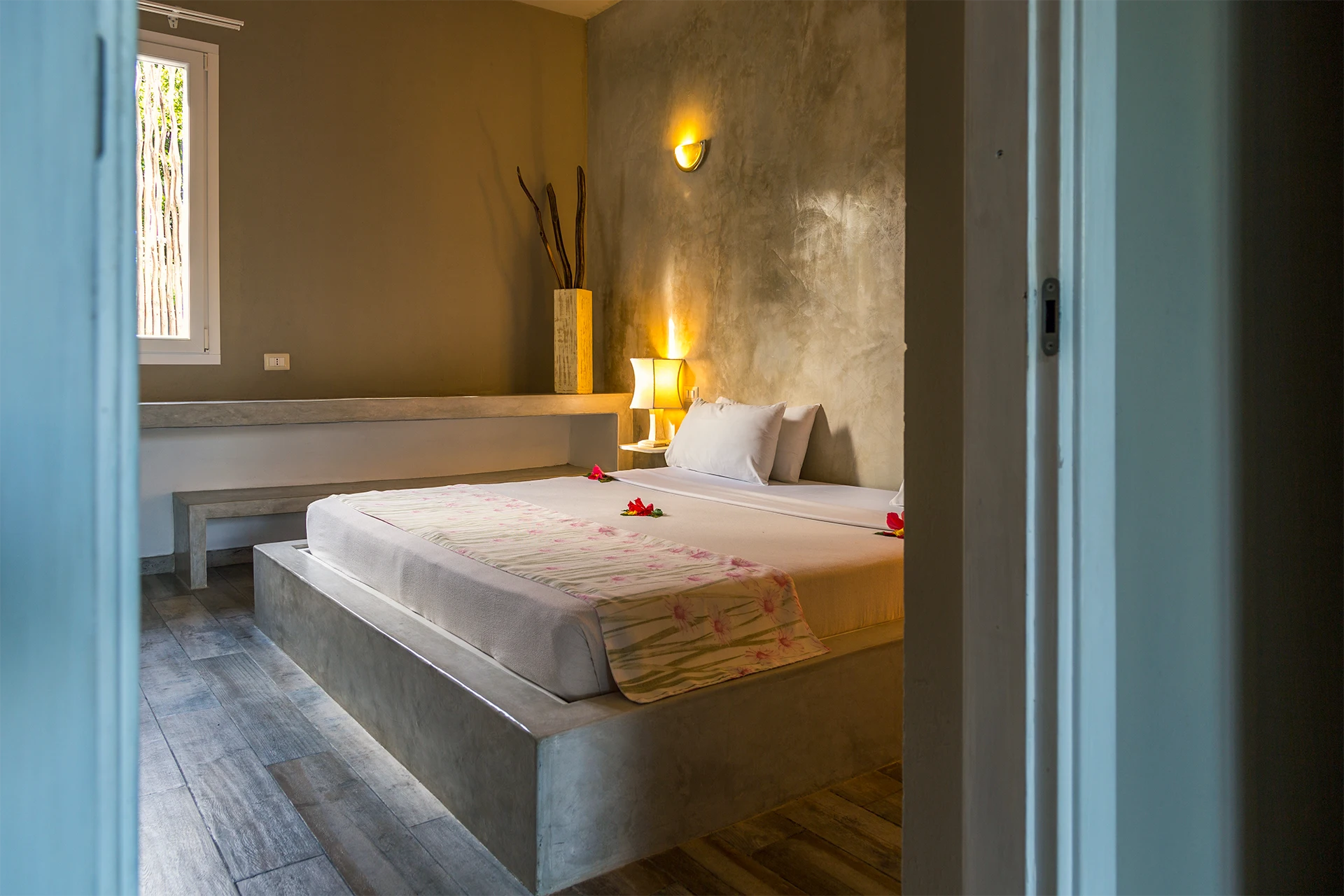 King-size bed with floral bedding in the Standard Garden View Suite