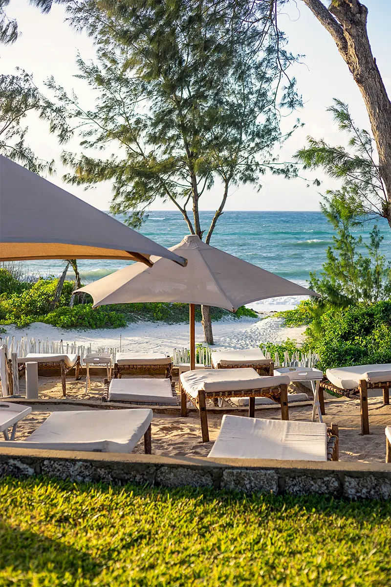 Beachfront loungers and umbrellas overlooking the white sands of Garoda Beach in Watamu