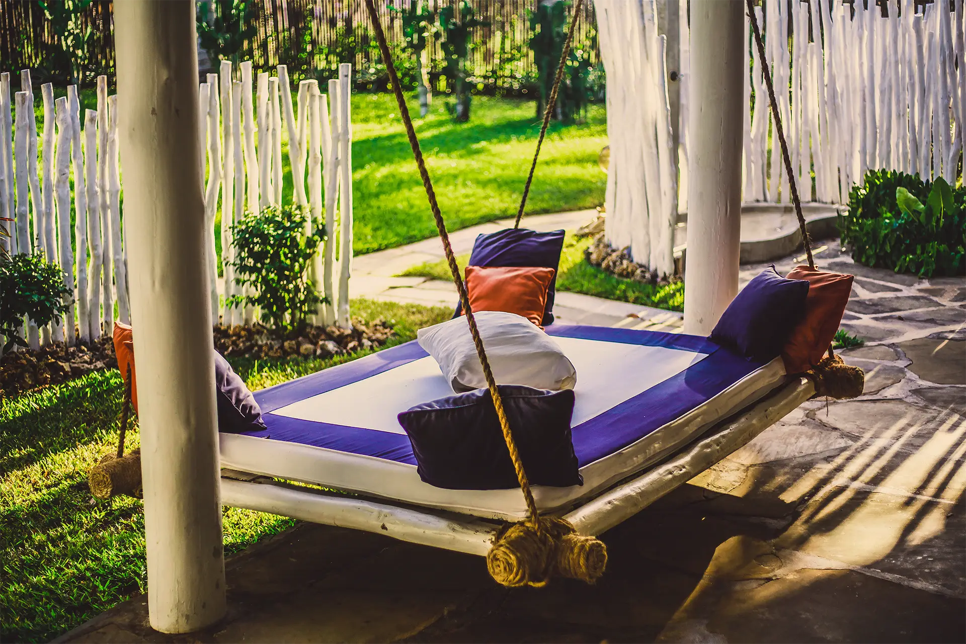 Hanging daybed in the tropical garden outside the Ocean View Suite
