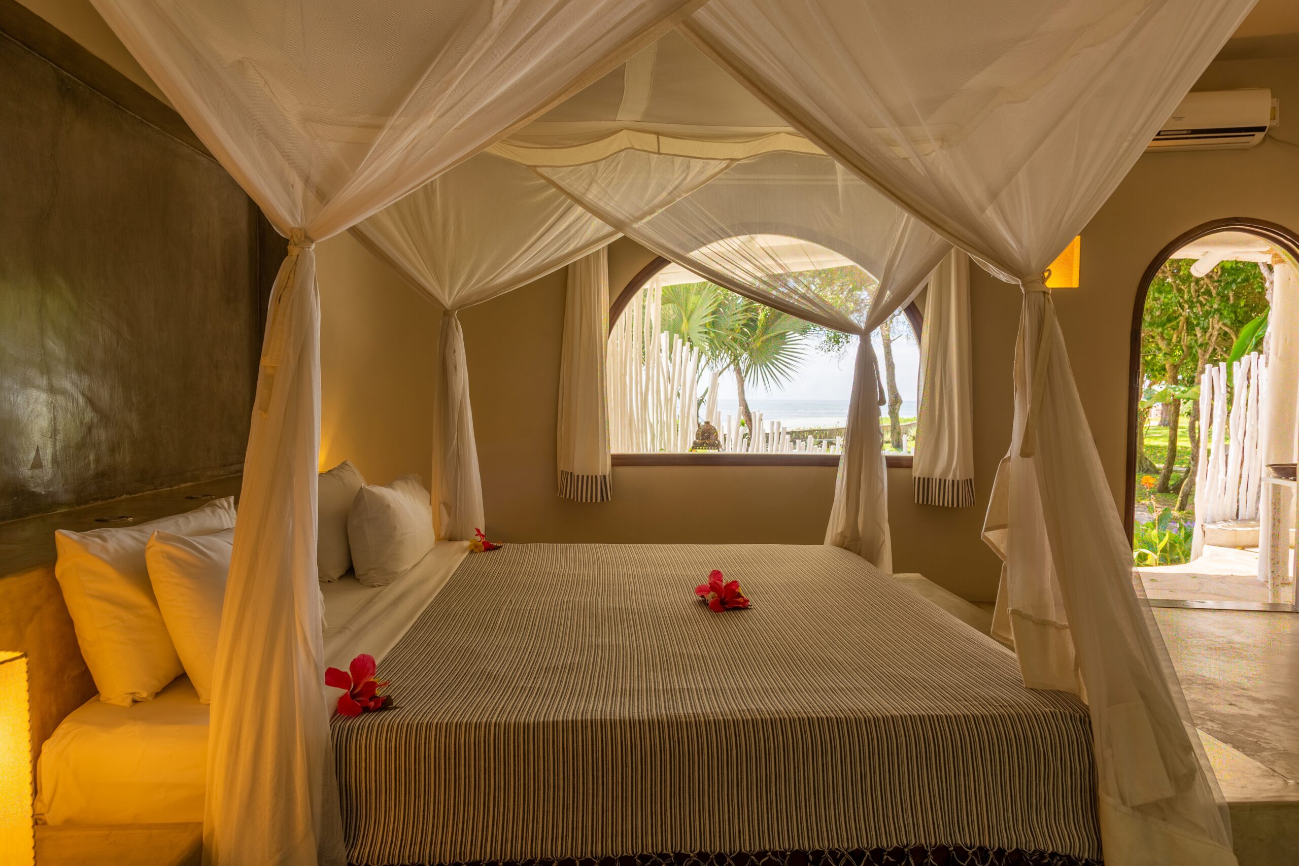 King-size bed with mosquito net and ocean view in the Ocean View Suite