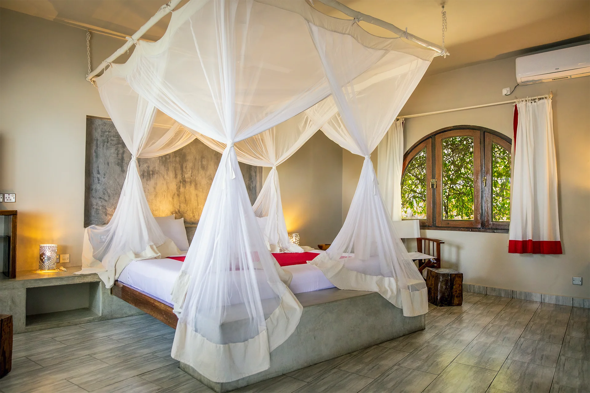 King-size bed with a mosquito net in the Ocean View Suite