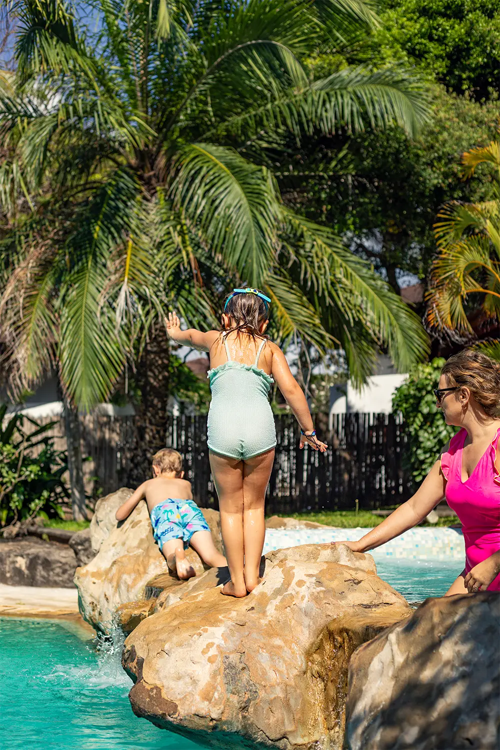 Mother and children enjoying the swimming pool at Kobe Suite Resort