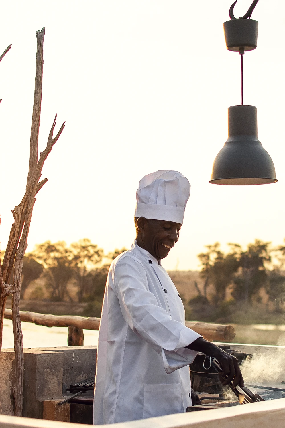 Chef preparing dinner at Kudu Safari Camp overlooking the African landscape