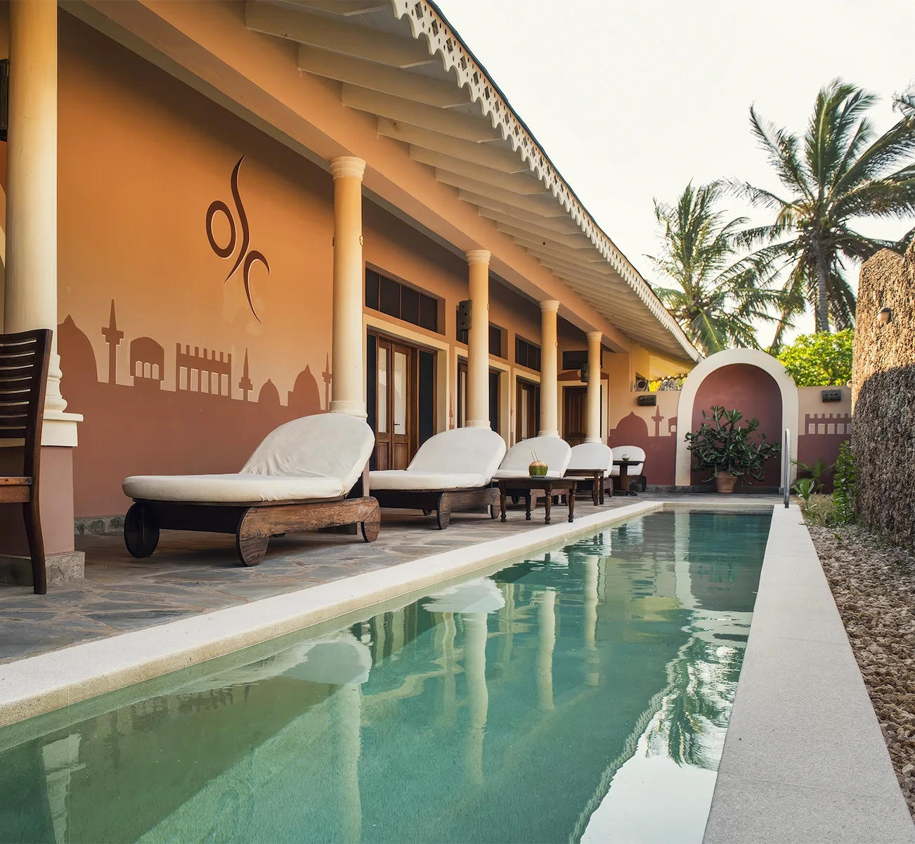 Private pool with sun loungers surrounded by tropical gardens at Kobe Suite Resort