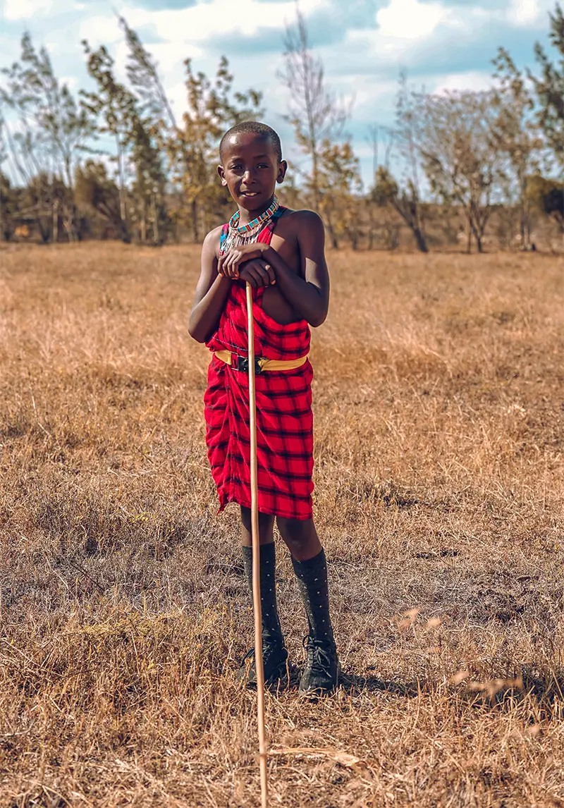 Child wearing traditional Maasai-inspired clothing in Kenya