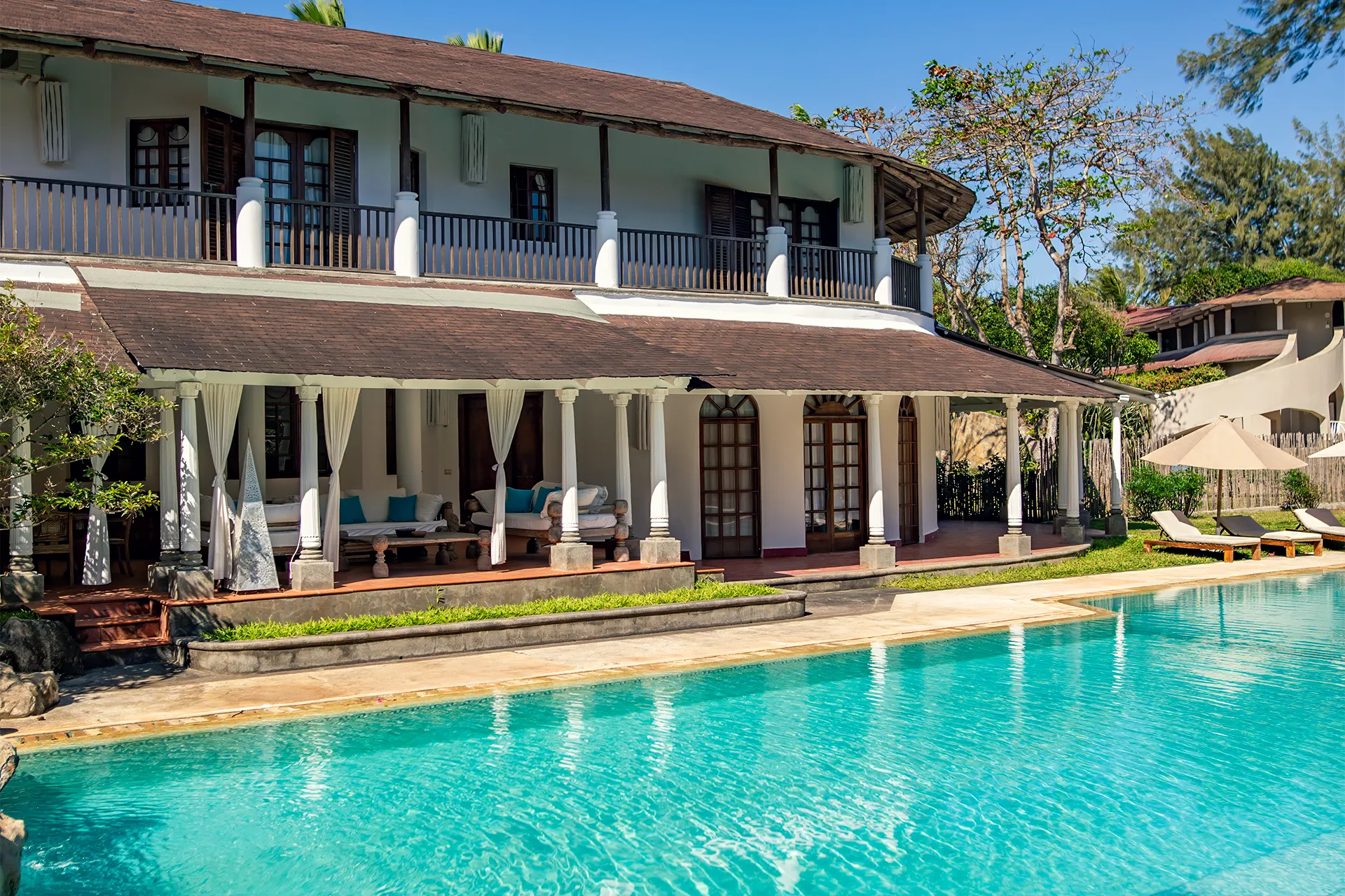 Private villa with swimming pool, tropical gardens and outdoor dining area